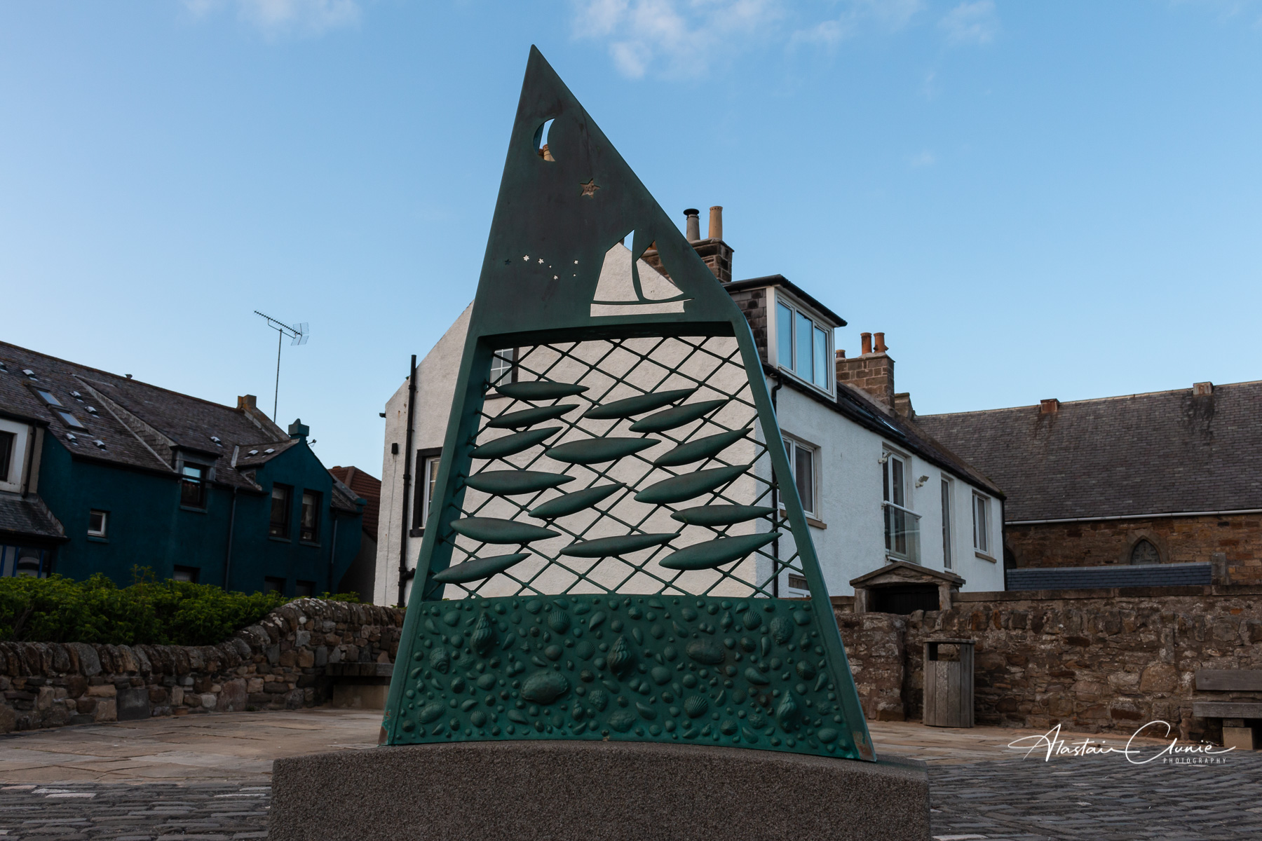 sculpture of fish, nets and boats